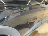 a close up of a car ' s door handle with a sticker on it