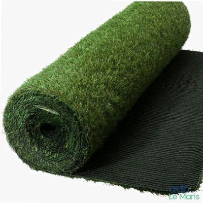 a roll of artificial grass on top of a black mat