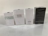 three boxes of perfume sitting next to each other on a table