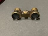 a small pair of binoculars sitting on a table