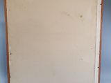painting on the wall of a room with a blue wall and a wooden frame