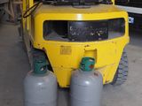 a yellow forklift truck with two gas cylinders on the back
