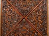 a wooden wall hanging with a decorative design on it