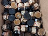 une boîte en carton remplie de bocaux contenant différentes sortes de sauces