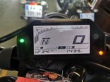a close up of a motorcycle with a display on it ' s dashboard