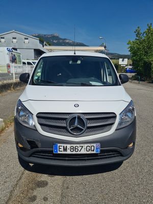 the white van is parked on the side of the road