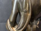 bronze statue of a woman holding a baby in her arms