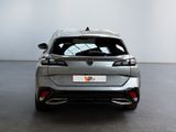 the rear end of a silver car in a white room