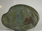 a sculpture of a bear swimming in the water