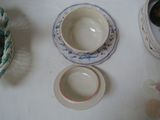 a white table topped with bowls and plates on it
