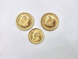 trois pièces d'or portant l'image d'un homme et d'une femme