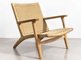 the chair is made of wood and has a woven seat