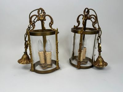 pair of antique brass lanterns with clear glass and gold accents