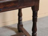 a wooden table with a drawer on top of it