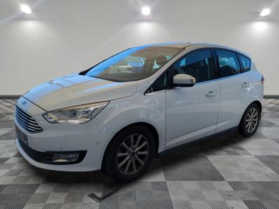 a white ford c - max parked on a checkered floor