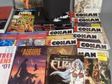 a lot of comic books sitting on a table