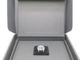 a box with a watch inside of it on a white background