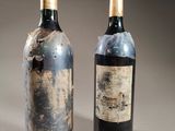 two bottles of wine sitting next to each other on a table