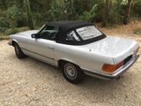 an image of a silver car parked in a gravel lot