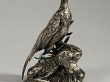 silver plated figurine of two birds perched on a tree branch