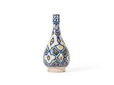 l'image d'un vase bleu et blanc posé sur une table