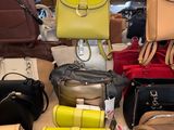 a lot of purses on a table in a store