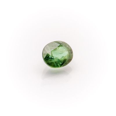 a green tourmaline gems on a white background