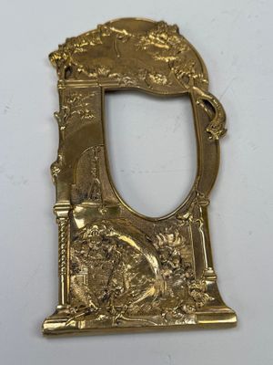 a close up of a gold plate with a mirror on it