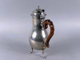 an antique silver coffee pot with a wooden handle on a white background