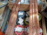 several pieces of copper are stacked on a pallet in a warehouse