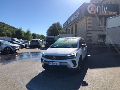 the white car is parked in front of a building in a parking lot