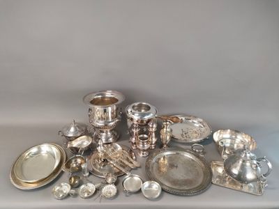 a pile of silver dishes and silverware on a table