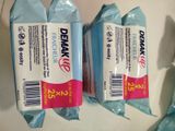 two packages of dental wipes sitting on top of a table