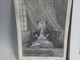 an old book with a drawing of a woman sitting on a bed