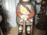 a statue of a man in armor holding a sword