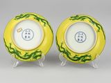 two yellow and green plates with dragon designs on them