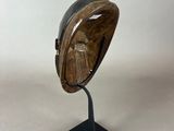 statue of a bird perched on a shell on a black stand