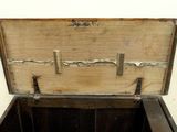 an old wooden chest with a metal latch on it