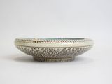 a close up of a white bowl on a white surface
