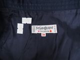 the back of a blue jacket with a white label on it