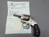 a revolver that is sitting on top of a piece of paper
