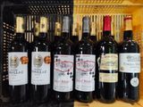 many bottles of wine in a crate on the shelf