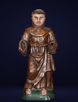 an antique bronze statue of a monk with a green base