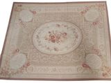 beige area rug with a floral design on a white background