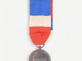 a medal with a red, white and blue ribbon on it