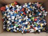 a cardboard box filled with lots of small toys