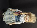 a doll that is standing on a black surface