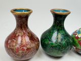 three vases sitting next to each other on a table