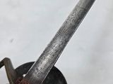 a knife stuck in a pot on the stove