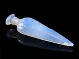 a small plastic bottle with a clear cap on a black surface